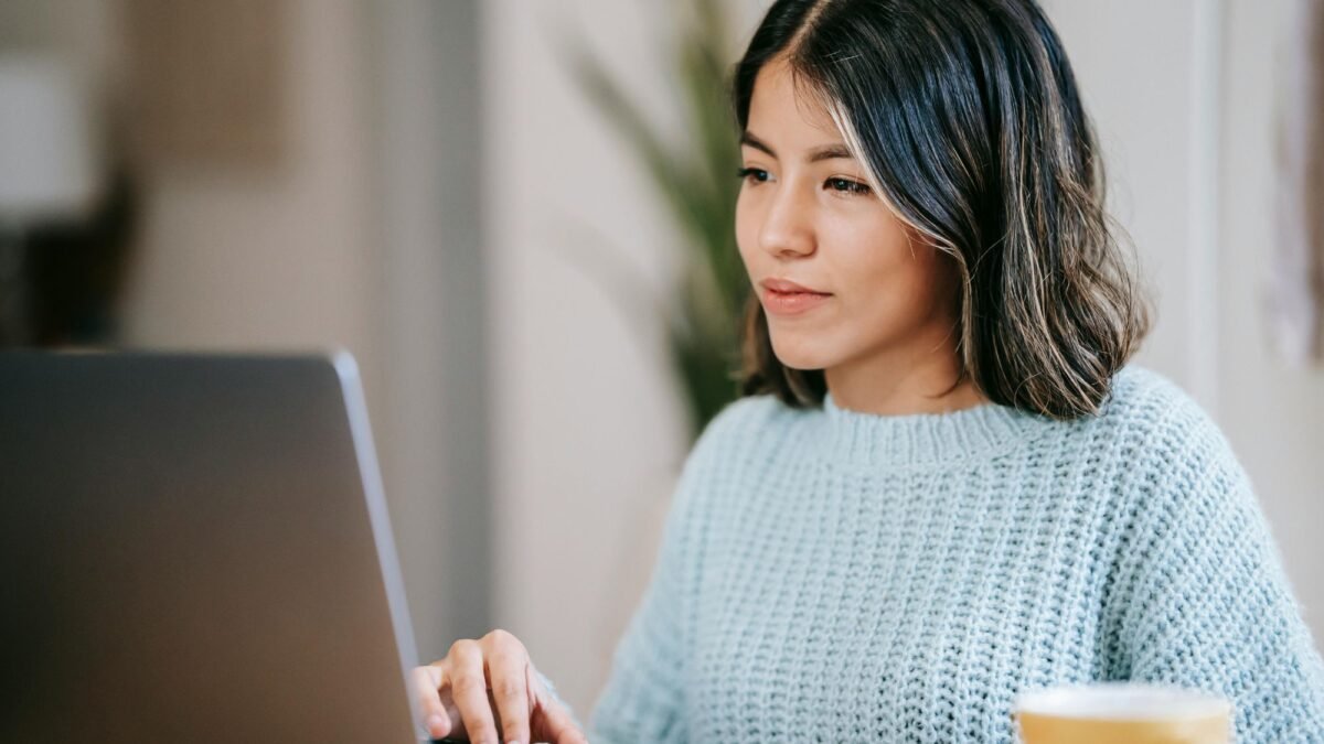 A girl designing a brand design on her laptop to improve brand identity