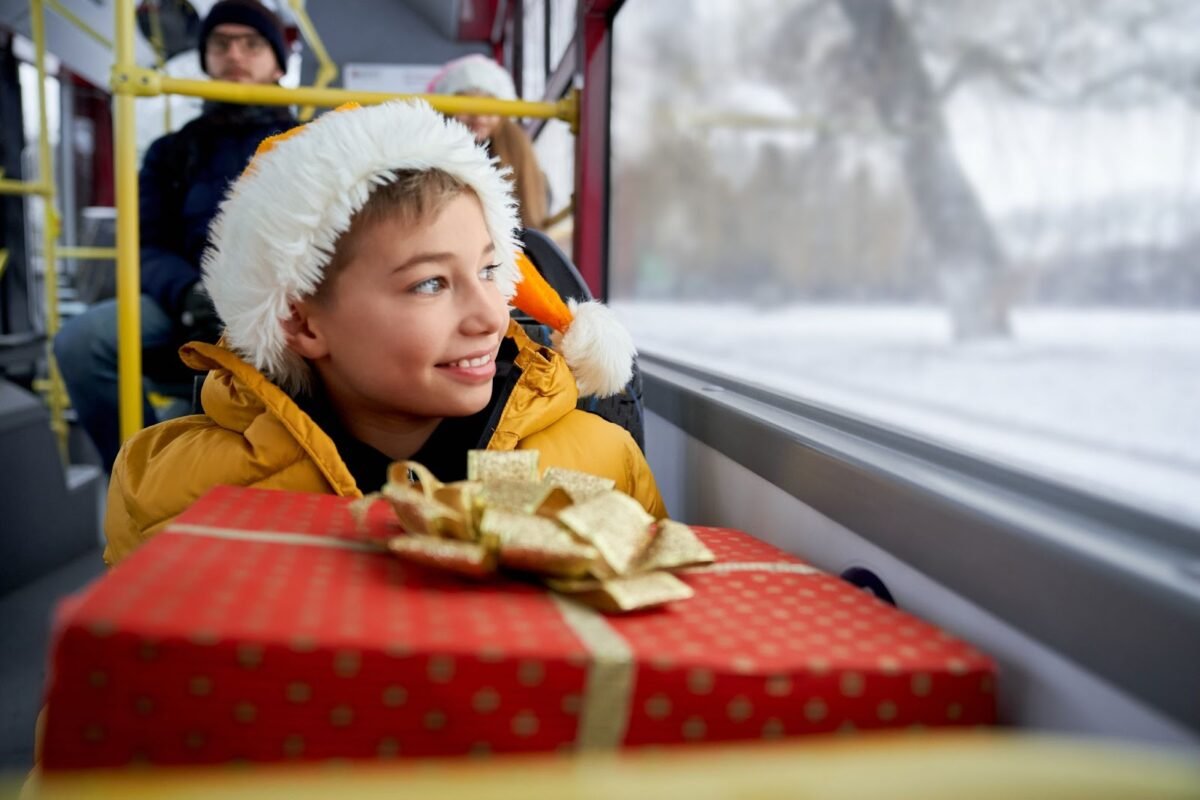 A kid is traveling in the Christmas bus