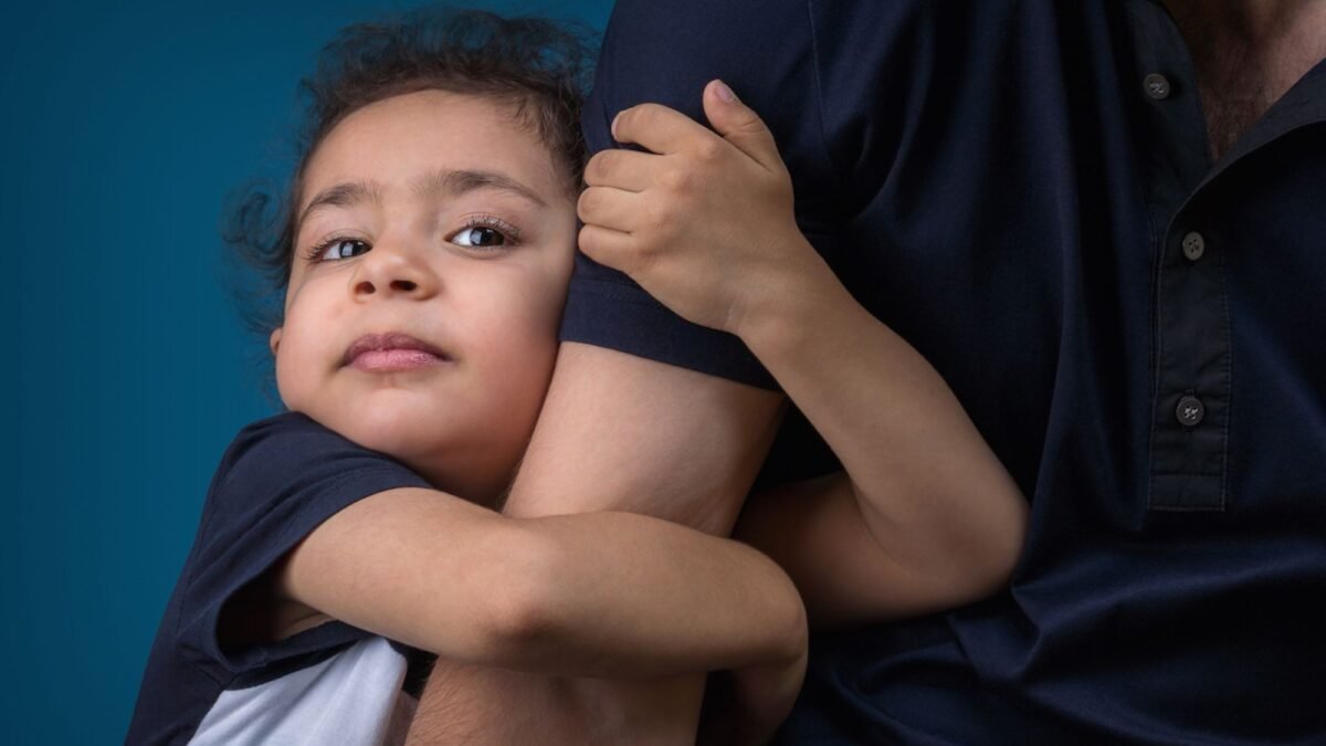 A little cute girl hugging her father after a child custody case hearing
